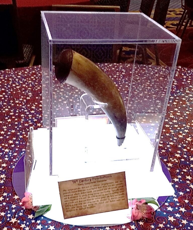 18th century powder horn replica in an acrylic case