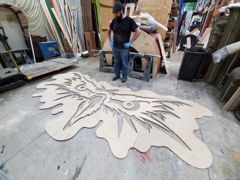 Large carved scenic panel on the workshop floor