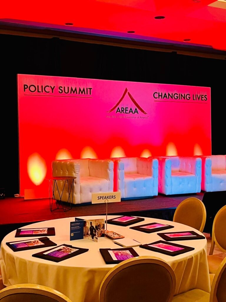 Policy summit stage with branded backdrop