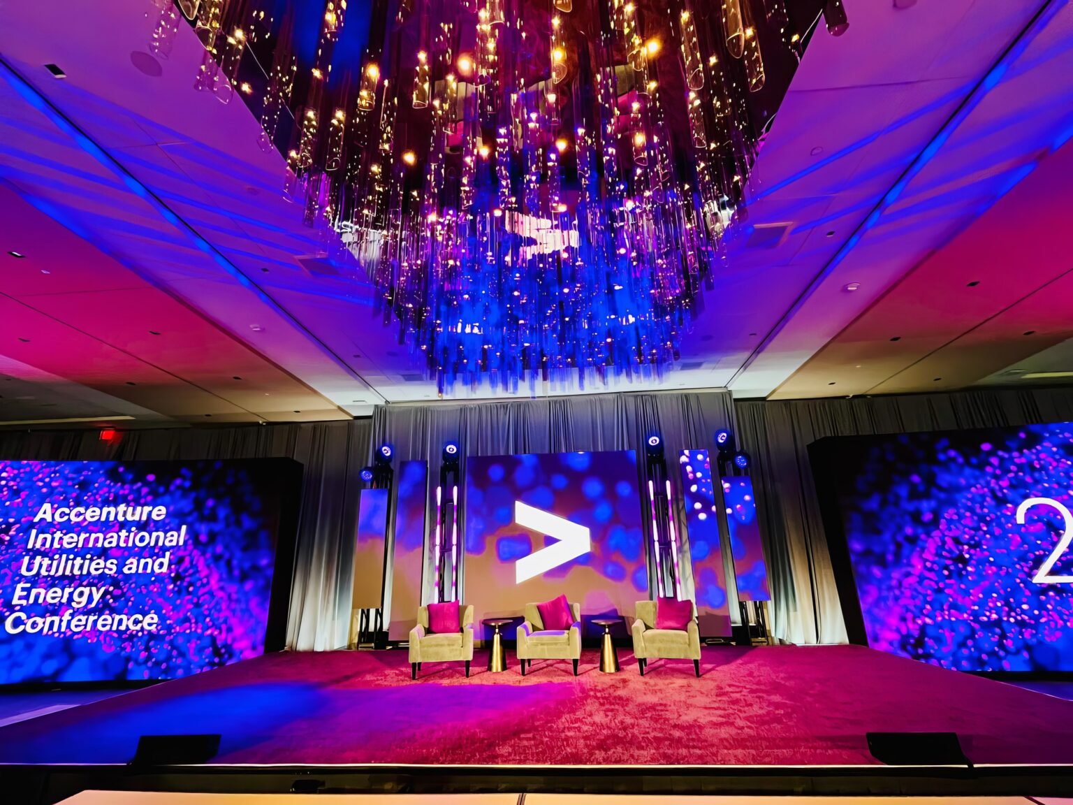 Conference stage with LED screens and lit scenic elements