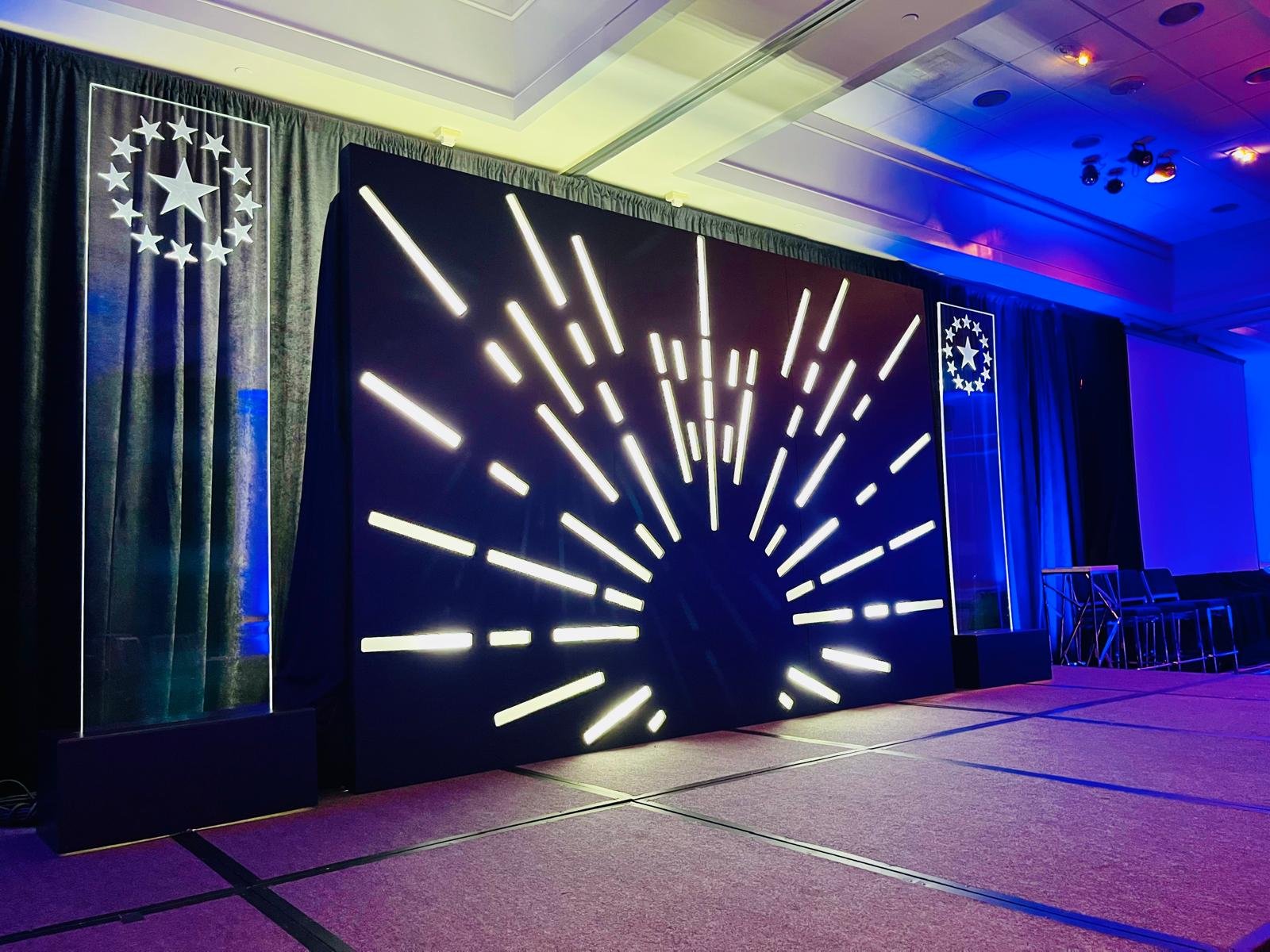 Conference stage with LED sunburst scenic wall
