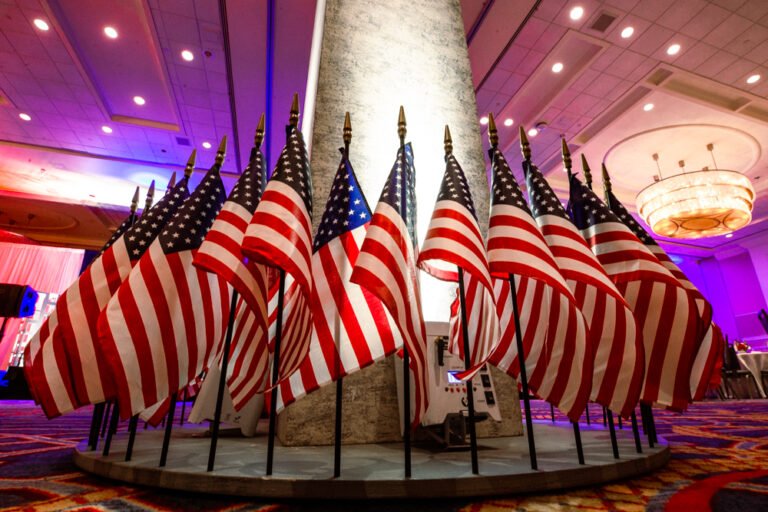Washington Monument replica surrounded by American flags at an event
