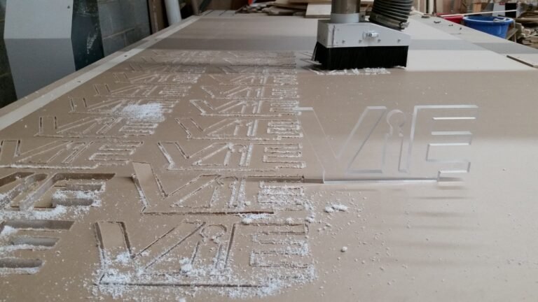 Acrylic pieces being CNC cut