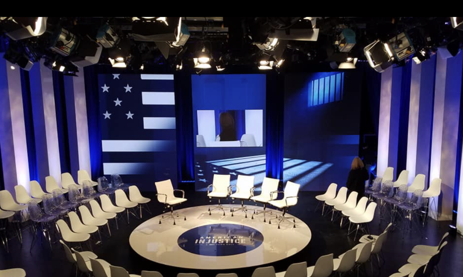 American Injustice broadcast set with columns and LED flag wall